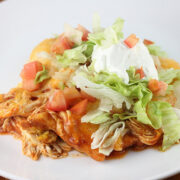 Chicken tamale bake with shredded lettuce, tomatoes, and sour cream
