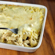 Fork lifting cheesy chicken tetrazzini from the casserole