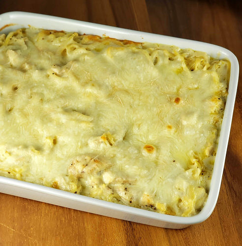 Chicken tetrazzini casserole topped with a golden cheese layer
