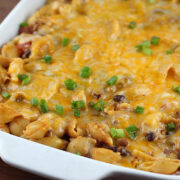 Chili pasta bake topped with melted cheese and green onions