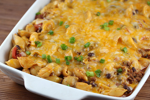 Chili pasta bake topped with melted cheese and green onions