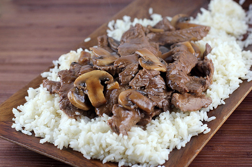 Plated beef and mushrooms on a bed of rice