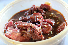 Raw beef strips marinating in sauce