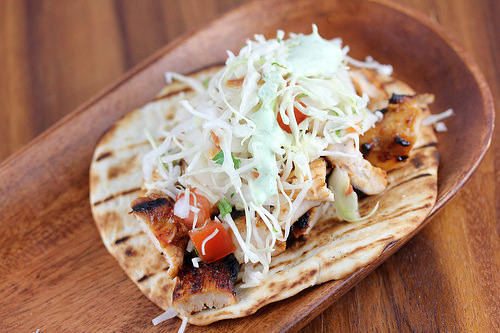 Chipotle chicken tacos loaded with fresh cabbage and tomato slaw