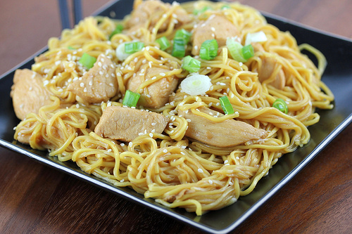 Chicken chow mein served on a black plate