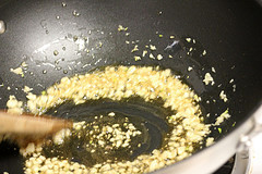 Garlic sautéing in oil in a wok