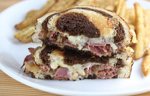Corned beef grilled cheese sandwich with melted cheese on marbled rye