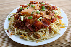 Plate of cowboy spaghetti with cheese and bacon