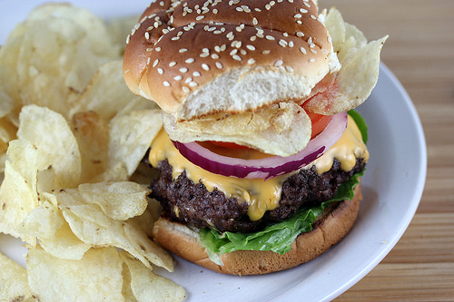Crunchburger served with potato chips on a plate