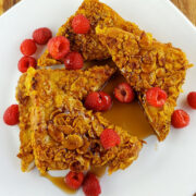 Crunchy French toast slices with raspberries and syrup