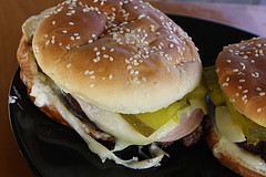 Stacked Cuban burgers with cheese and pickles