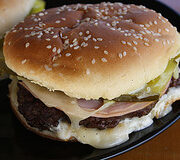 Cuban burger with pickles and melted cheese