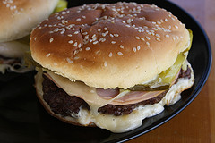 Cuban burger with pickles and melted cheese