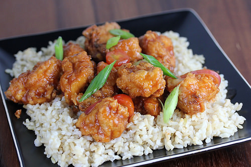 Sweet and savory chicken over rice garnished with scallions