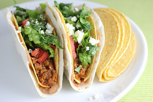 Double decker tacos served with crispy shells on the side