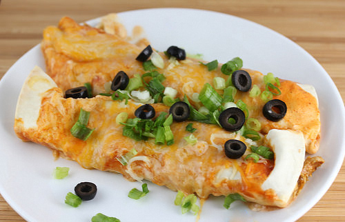 Easy enchiladas topped with cheese and sliced olives