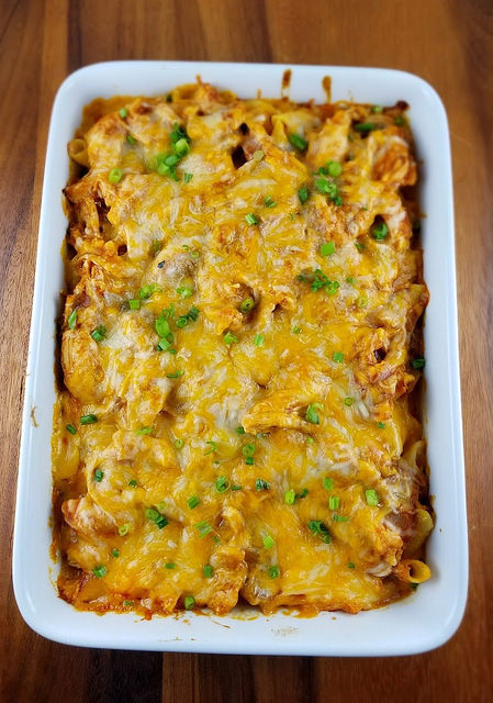 Cheesy enchilada chicken penne casserole in a white dish