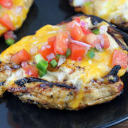 Fiesta lime chicken with cheesy topping and lime garnish