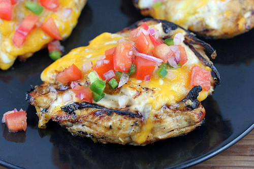 Fiesta lime chicken with cheesy topping and lime garnish
