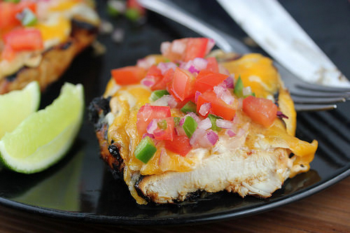 Fiesta lime chicken topped with melted cheese and fresh pico de gallo