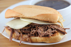 French dip sandwich with melted cheese and au jus