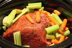 Beef roast with carrots and celery in slow cooker