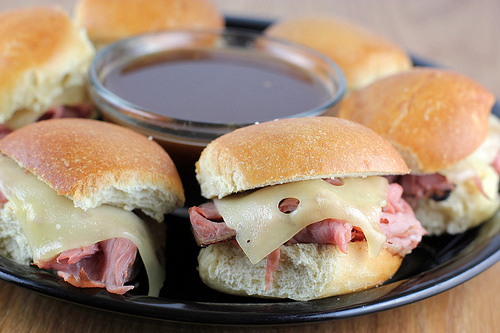 French dip sliders with roast beef, Swiss cheese, and au jus