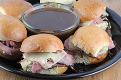 French dip sliders with roast beef, Swiss cheese, and au jus