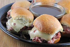 French dip sliders with roast beef, Swiss cheese, and au jus