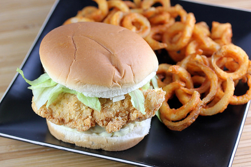 Chicken sandwich with lettuce and curly fries
