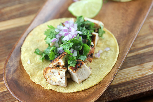 Grilled chicken street taco topped with cilantro and onions