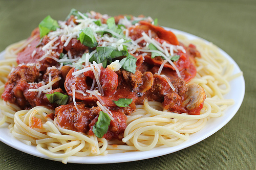 Close up of spaghetti with Italian meat sauce and herbs