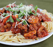 Spaghetti with tomato meat sauce and grated cheese