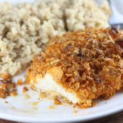Kettle chip crusted chicken with rice on a white plate