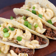 Mac and cheese tacos filled with ground beef and scallions