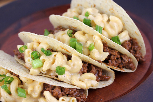 Mac and cheese tacos filled with ground beef and scallions