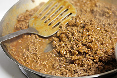 Ground beef cooking in skillet with sauce