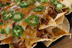 Beef nachos topped with cheese and fresh jalapeño slices