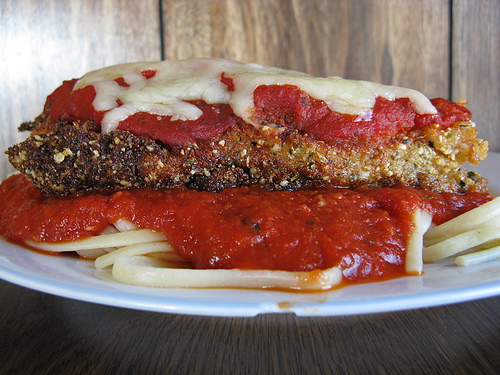 Chicken parmesan served on spaghetti