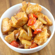 Sweet sticky chicken with pineapple and red peppers served in a bowl
