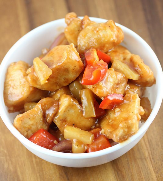 Sweet sticky chicken with pineapple and red peppers served in a bowl