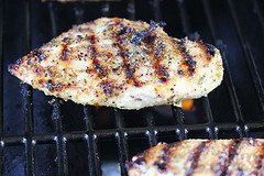 Montreal seasoned chicken grilling on barbecue