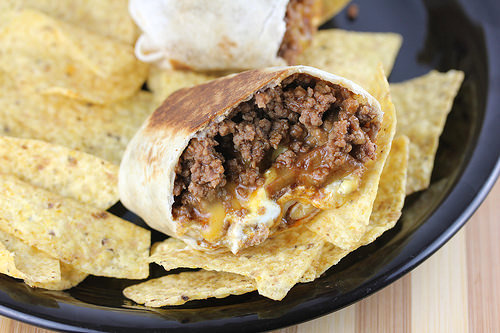 Cheesy beef burrito served with tortilla chips