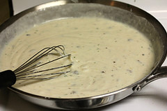 Creamy ranch sauce whisked in skillet