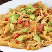 Chicken enchilada pasta topped with avocado