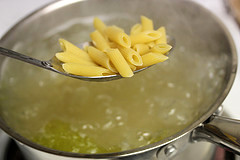 Penne pasta cooking in boiling water