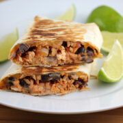 Sliced grilled chicken burrito on plate