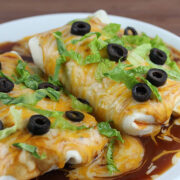 Smothered chicken burritos with lettuce and olives