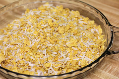 Coconut chicken coating spread in baking dish