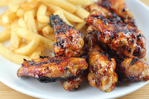 Honey bbq chicken wings served with fries